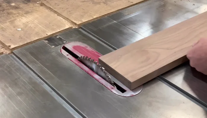 Set up the table saw: Adjust the blade to be even with the 1/4-inch line. Attach an auxiliary fence.