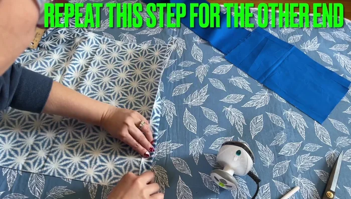 Hem the main body fabric: Fold and iron 1 inch hems on both short sides of the main fabric.