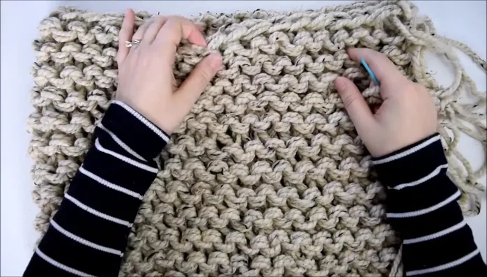 Prepare your yarn: Cut two arm lengths of double-stranded yarn and thread it onto your yarn needle.