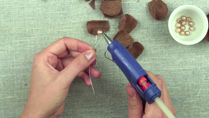 Continue forming the flower by overlapping 5-6 petals. Fan up the flower and add an extra detail to the center if desired.