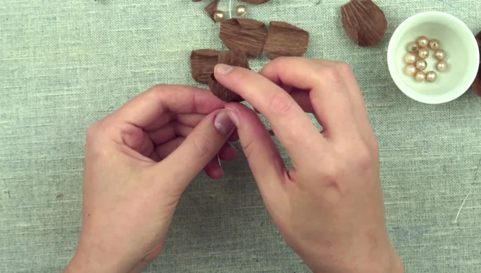 Continue forming the flower by overlapping 5-6 petals. Fan up the flower and add an extra detail to the center if desired.