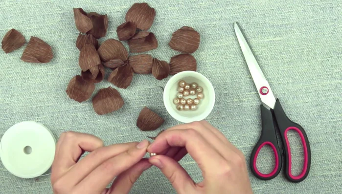 Thread a central bead with craft wire and twist, leaving about 6 inches of wire. Cut off the excess.