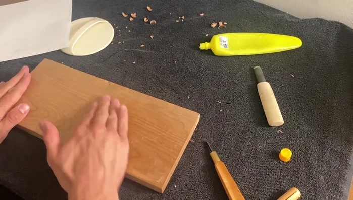 Gently peel the paper away, dampening your fingers to help release the paper. Work slowly and carefully to avoid tearing the paper.