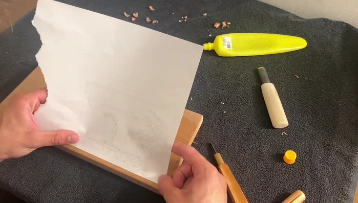 Gently peel the paper away, dampening your fingers to help release the paper. Work slowly and carefully to avoid tearing the paper.