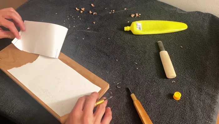 Gently peel the paper away, dampening your fingers to help release the paper. Work slowly and carefully to avoid tearing the paper.