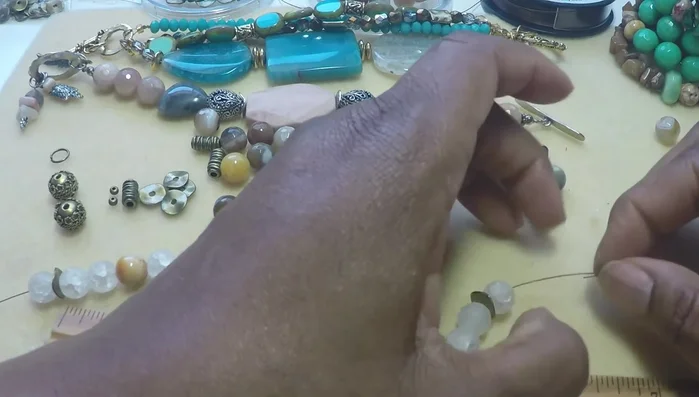 Continue threading the wire through the beads until you reach the middle.