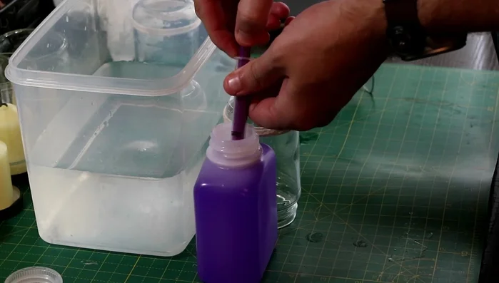 Using a syringe, apply methylated spirits to the string.