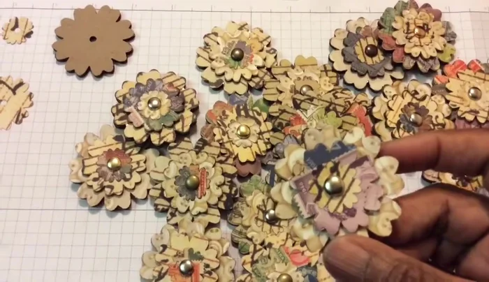 Use a laser cutter to precisely cut out the flower shapes from all three layers of material.