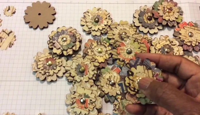 Prepare three layers of different sizes for each flower: a large cardboard layer, a medium chipboard layer, and a small paper layer.