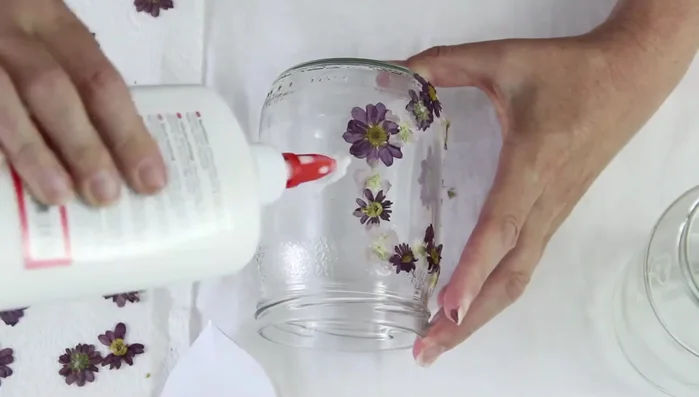 Add more flowers to the top and bottom of the jar.