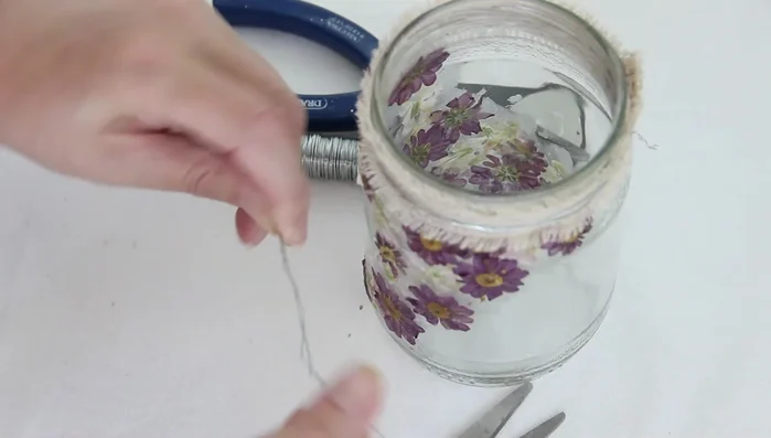 Create a handle and a heart hanger using floral wire. Twist the wire together to strengthen it, and attach securely to the jar.