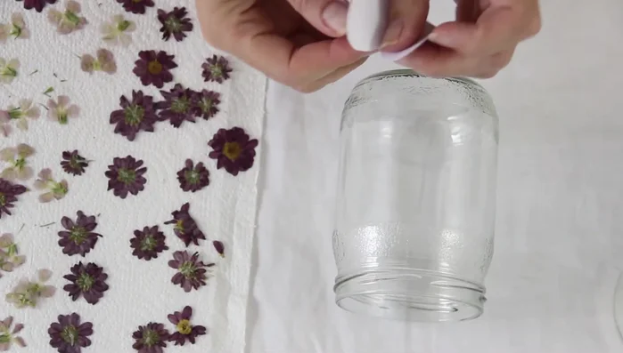 Cut a heart-shaped template from paper and temporarily stick it to the front of the jar using sticky tape.