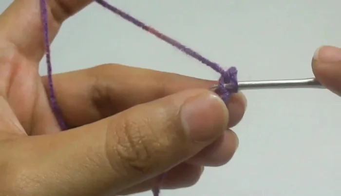 Chain three, then work four double crochet in the same stitch. Pull through two loops twice.