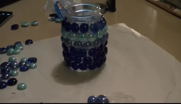 Add finishing touches: Once completely dry, insert your candle and decorate the top with a ribbon or bow.