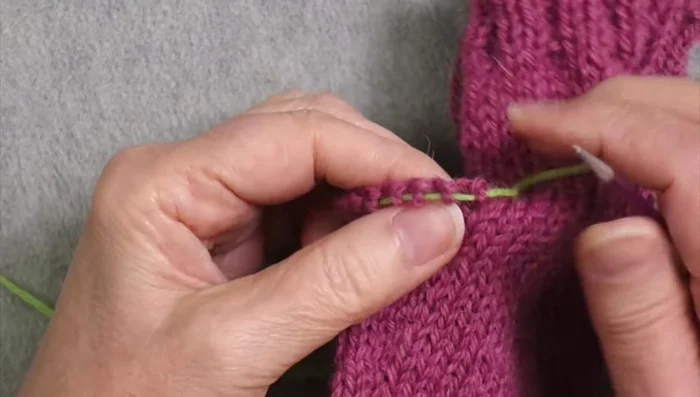Knit Thumb: Pick up stitches along the edge where the thumb was separated, adding extra stitches to avoid gaps (and then decreasing those extra stitches later). Knit thumb to desired length, switching to ribbing for the final section.