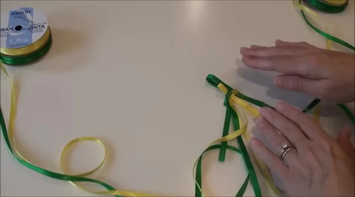 Maintain neatness: Regularly check and adjust the braid to keep it even and tidy. Use your fingers to hold and guide the ribbons.