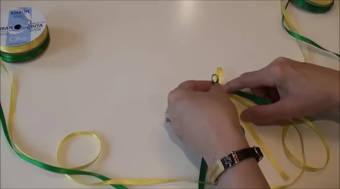 Maintain neatness: Regularly check and adjust the braid to keep it even and tidy. Use your fingers to hold and guide the ribbons.