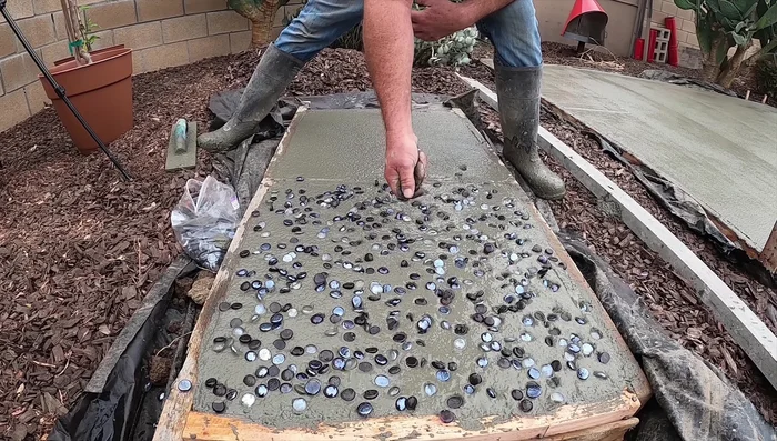 Wait at least 4-6 hours (depending on weather) for the concrete to set partially.