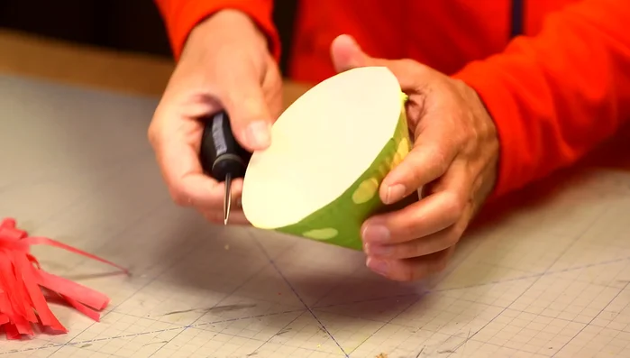 Make a string and thread it through the holes to create a chin strap.