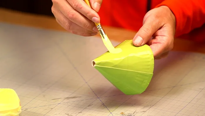 Decorate the hat (e.g., with yellow spots).