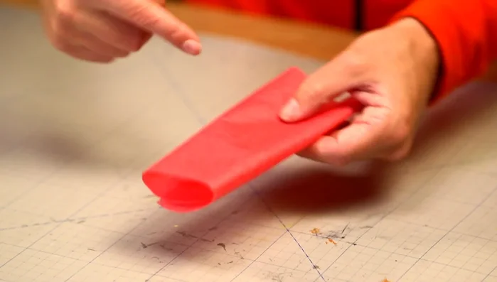 Create paper frills using colored silk paper: fold it, cut it into stripes, and roll it up.