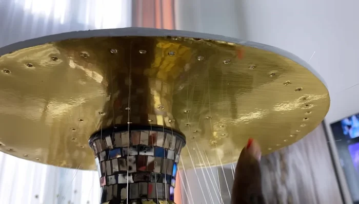 Cover the sides of the structure with gold contact paper and use strong adhesive and hot glue to secure the top foam board.