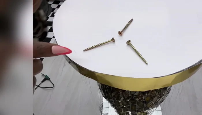 Mount the finished light fixture to a ceiling or other surface using screws, command strips, or cup hooks. The video uses screws.