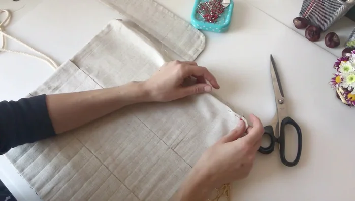 Attach the cap: Measure 1 cm down from the top of the cap, stitch it to the inside of the case using sewing pins to keep everything aligned.