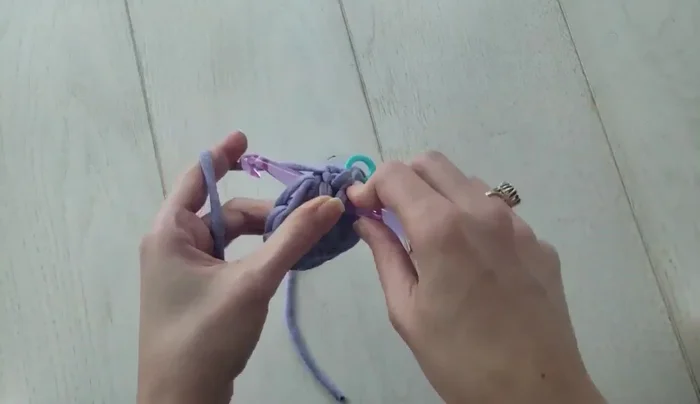 Round 3 and subsequent rounds: Work two linked double crochets in the first stitch, then alternate between one and two linked double crochets per stitch, increasing the number of stitches in each round until the desired pouf width is achieved.