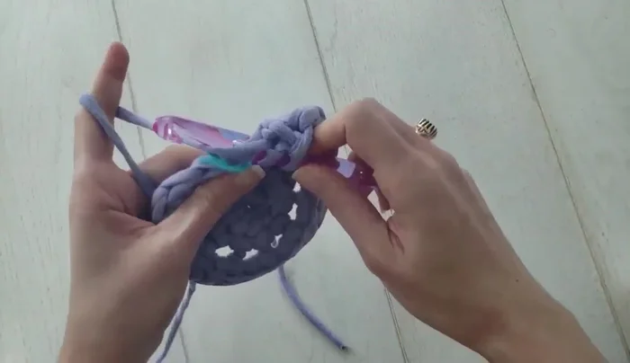 Round 3 and subsequent rounds: Work two linked double crochets in the first stitch, then alternate between one and two linked double crochets per stitch, increasing the number of stitches in each round until the desired pouf width is achieved.