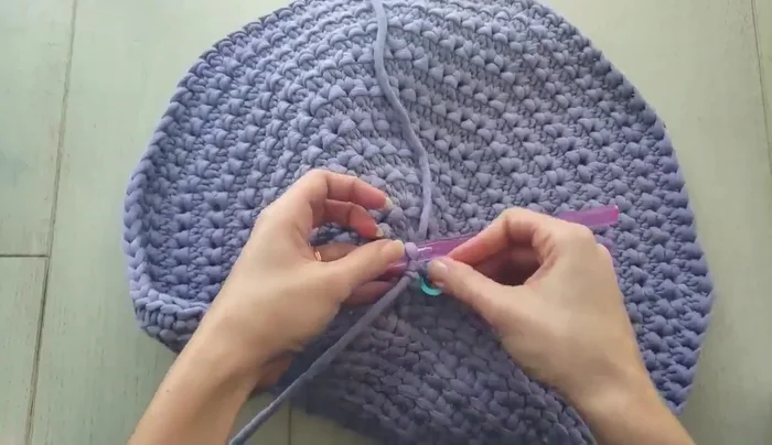 Seam up the remaining portion of the pouf, using a slip stitch to join the back loops of the stitches. Close any remaining holes by weaving in extra yarn.