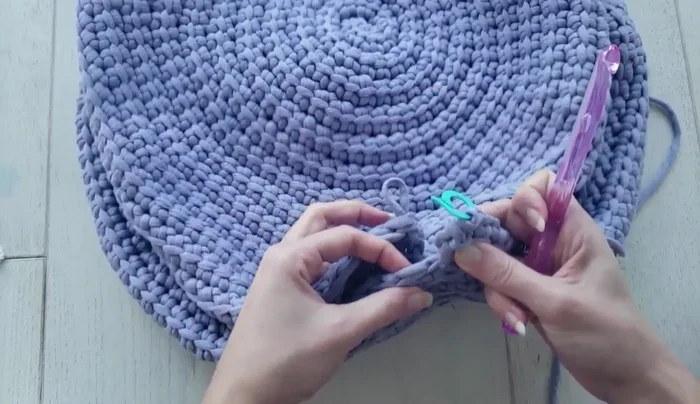 Seam up the remaining portion of the pouf, using a slip stitch to join the back loops of the stitches. Close any remaining holes by weaving in extra yarn.