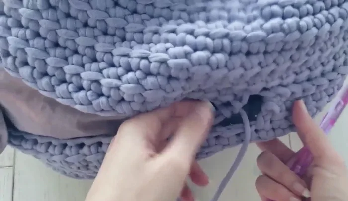 Seam up the remaining portion of the pouf, using a slip stitch to join the back loops of the stitches. Close any remaining holes by weaving in extra yarn.