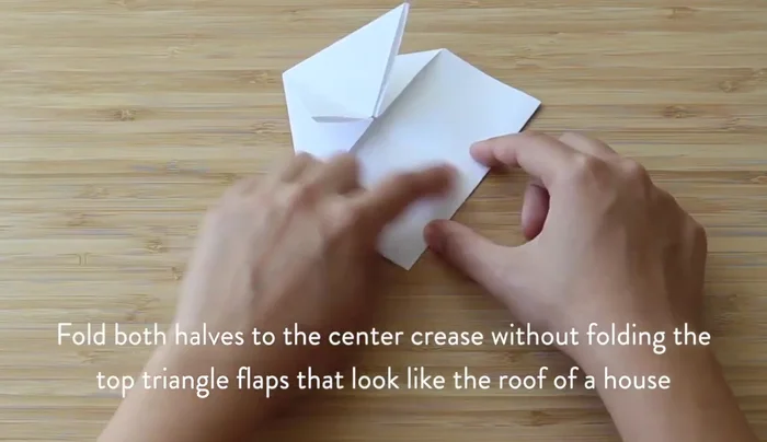 Fold the stem of the arrow shape in half to shorten it.