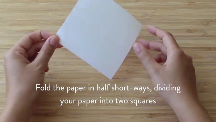 Fold the paper in half horizontally, then open it to reveal a horizontal line through the X.