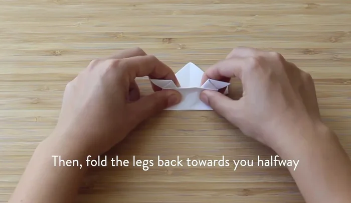 Fold the legs backwards like an accordion, creating a crease.