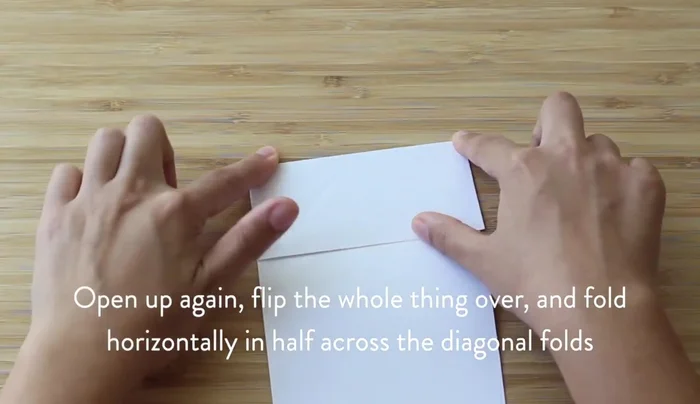 Fold the paper in half horizontally, then open it to reveal a horizontal line through the X.