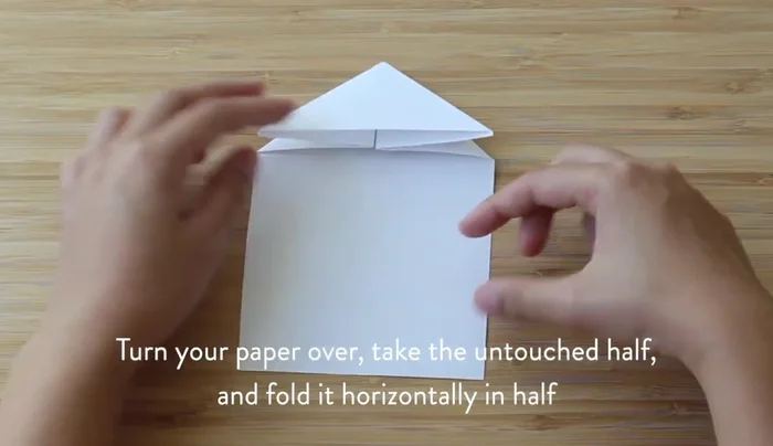Find the vertical center by folding the paper in half vertically, then open it.