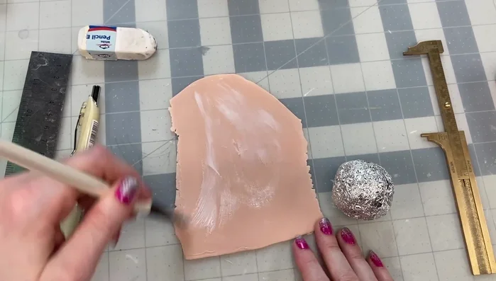 Apply polymer clay over the tin foil ball using liquid Sculpey as adhesive.