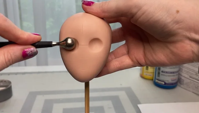 Shape the clay into a basic oval head form.