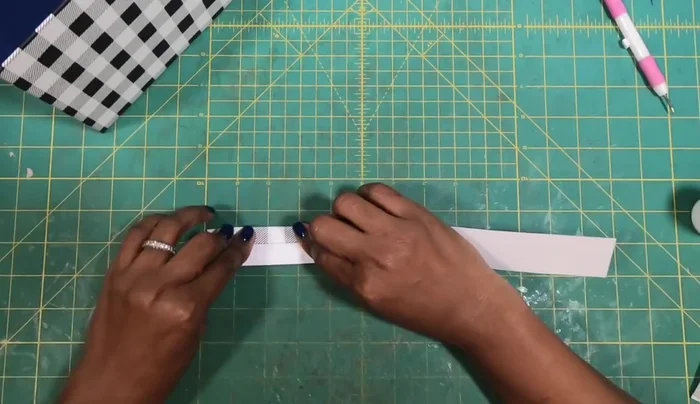 Create and Attach the Handle: Fold a strip of cardstock into thirds, glue it, and attach it to the top of the purse.