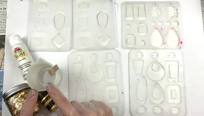 Add gold foil to the clear resin, ensuring even distribution.
