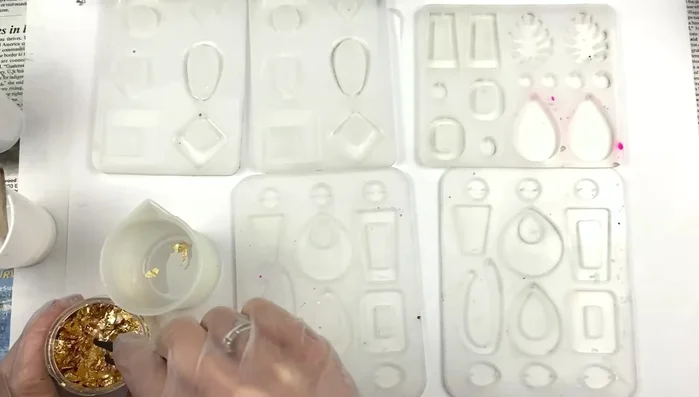 Add gold foil to the clear resin, ensuring even distribution.
