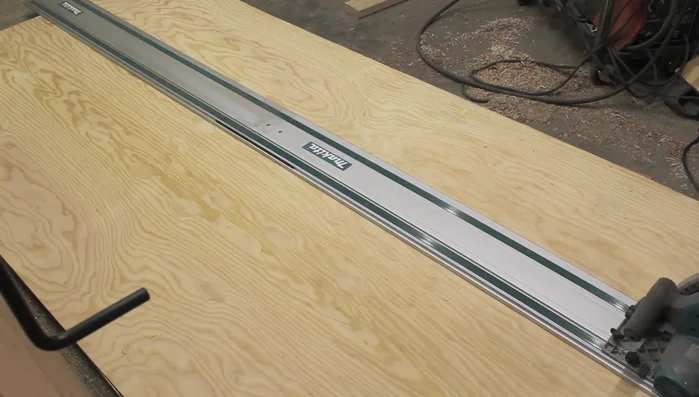 Apply contact cement to adhere a layer of poly wall to the plywood backing to prevent the wood grain from showing through the paint and to protect against gouges. Then paint with chalkboard paint.