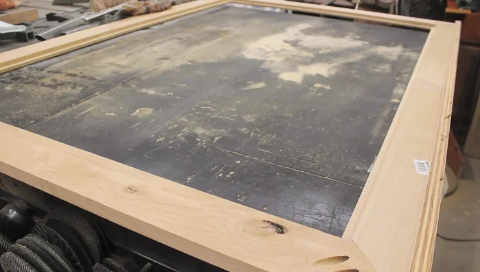 Drill keyhole slots in the back of the frame for hanging.