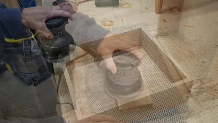 Final sanding and drawer front installation.