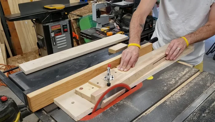 Cutting tapers on the legs using a tapering jig.