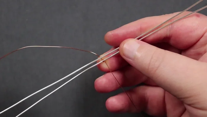 Create pyramids: Create three pyramids on each side, using the weaving wire to create a small pyramid shape with each section of two wraps. Make sure to maintain loose spacing between the base wires.