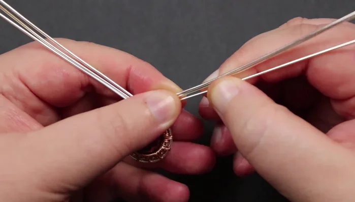 Secure remaining base wires: Wrap and secure the remaining base wires in the same manner, making sure to tuck the ends securely into the back of the piece.