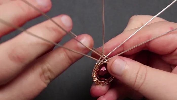 Secure remaining base wires: Wrap and secure the remaining base wires in the same manner, making sure to tuck the ends securely into the back of the piece.